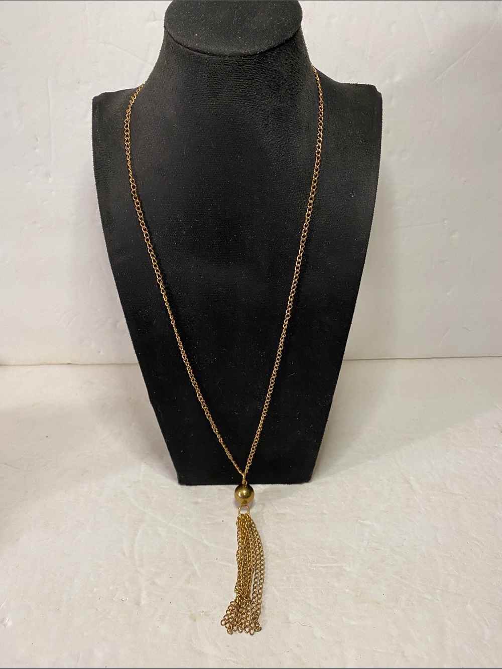 Gold tone tassel necklace